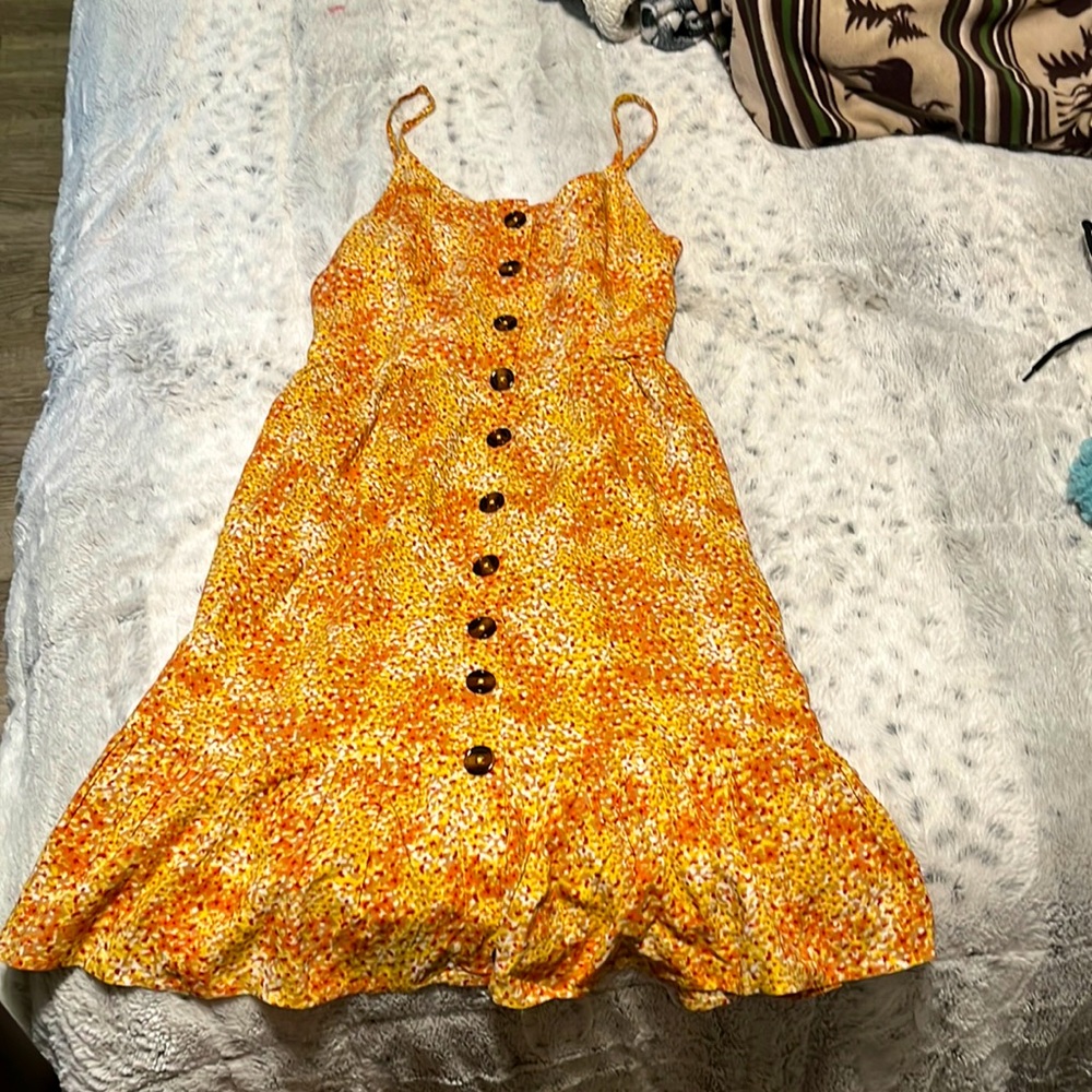 This is a cute orange and yellow dress. Its just above the knees.
